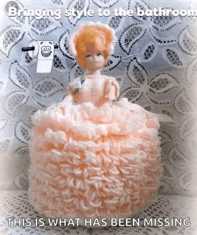 a doll in a pink dress is sitting on a roll of toilet paper with the caption bringing style to the bathroom this is what has been missing