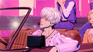 a man with white hair is sitting in a car with two other people