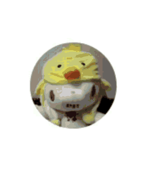 a stuffed animal wearing a yellow chicken hat with chinese writing on it