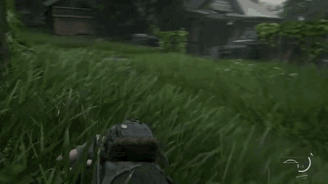 a person in a video game laying in the grass with a arrow pointing to the left