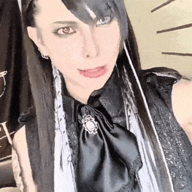 a close up of a woman wearing a black dress and a bow tie .