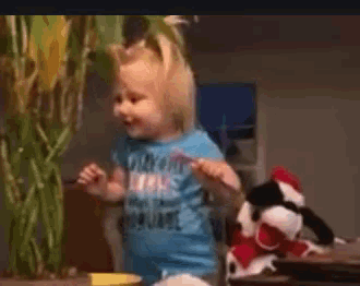 a little girl wearing a blue shirt that says ' nothing 's scarier than a square ' on it