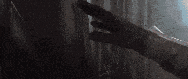 a person is touching another person 's face in the dark .