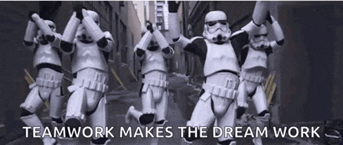 a group of stormtroopers are running down a street with the words teamwork makes the dream work written on the bottom .