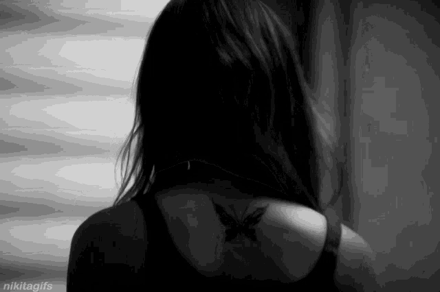 a woman has a butterfly tattoo on her back