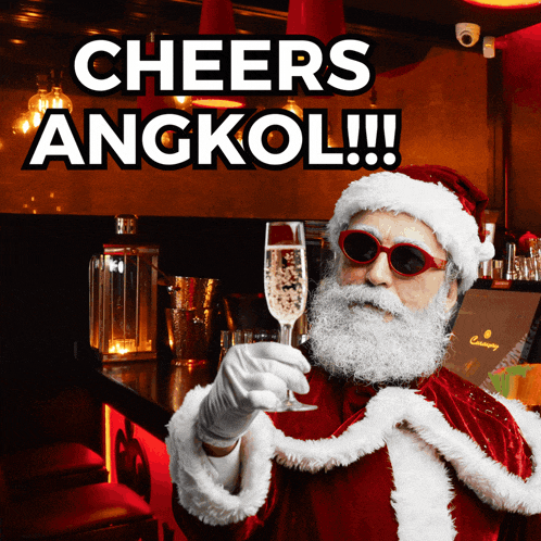 a man dressed as santa claus holds a glass of champagne