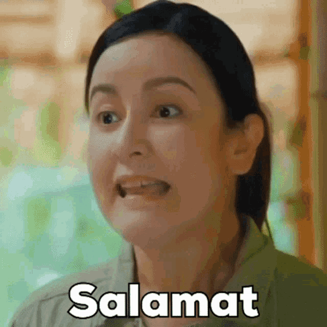 a woman is making a funny face and the word salamat is on her shirt