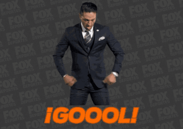 a man in a suit is dancing in front of a fox advertisement