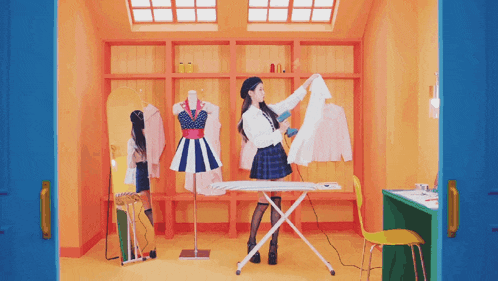 a woman in a plaid skirt is ironing clothes