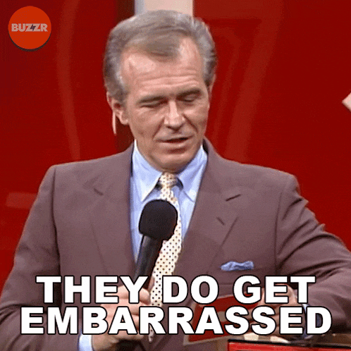 a man speaking into a microphone with the words they do get embarrassed