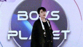 a man is standing in front of a logo for boys planet .