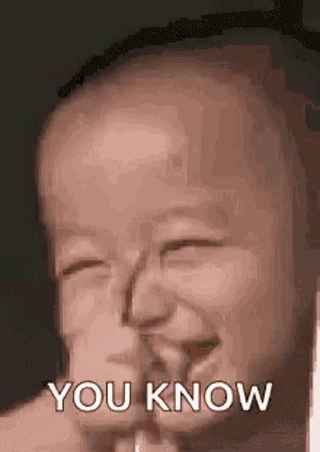 a baby is making a funny face and saying `` you know '' while holding something in its mouth .