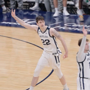 a basketball player wearing a butler jersey stands on the court
