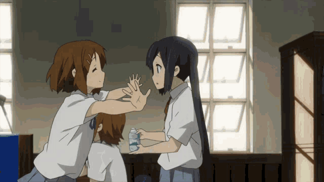 a girl in a white shirt holds a bottle of water