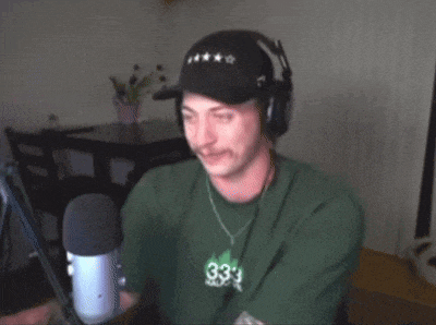 a man wearing headphones and a green shirt with the number 33 on the front