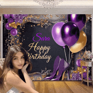 a woman poses in front of a happy birthday banner