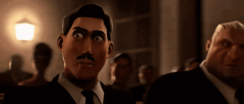 a man with a mustache is sitting in a dark room with other men .