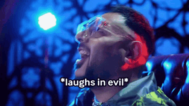 a man wearing glasses laughs in evil in a dark room