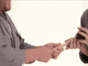 a man is holding another man 's hand in a blurry photo