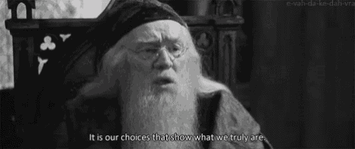 a man with a beard and glasses is sitting in a chair and saying it is our choices that show what we truly are