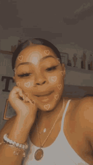 a woman with hearts on her face is smiling