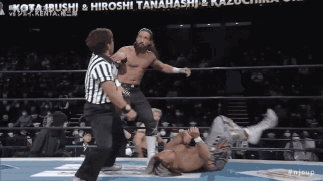 a wrestling match between kotabushi and hiroshi tanahashi