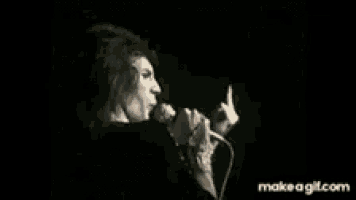 a woman singing into a microphone with the website makeagif.com in the corner