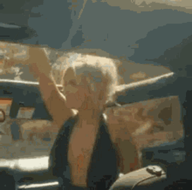a woman in a car with her arms outstretched