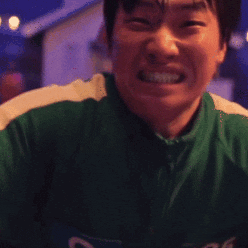a man in a green outfit is holding a piece of paper