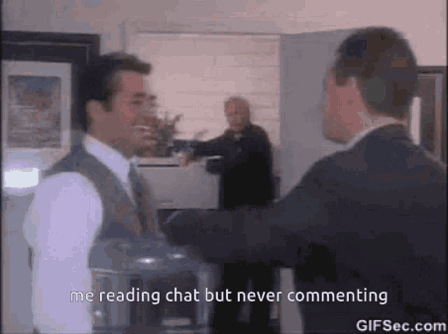 a man in a suit and tie is talking to another man