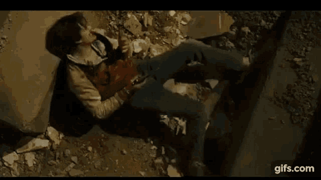 a man is laying on the ground with blood coming out of his face .