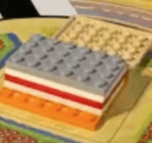 a stack of books sitting on top of each other on a table with an american flag made out of lego blocks .
