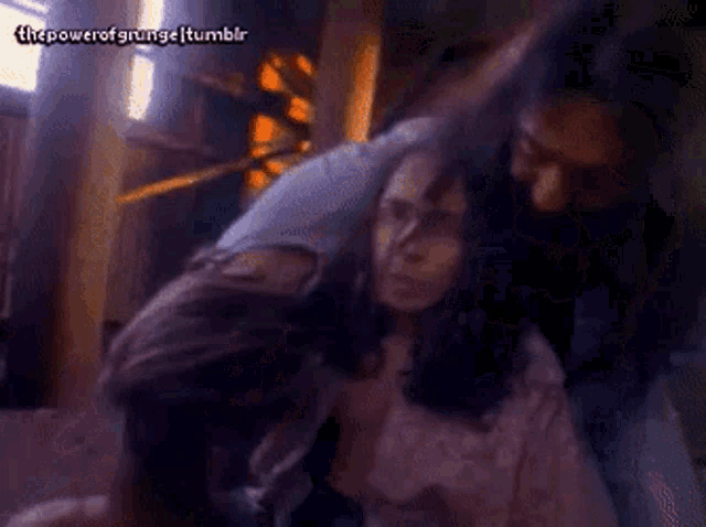 a man with a beard is holding a woman in a room with the power of grunge tumblr written in the corner