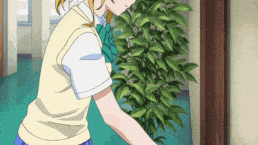 a girl in a school uniform stands in a hallway next to a plant