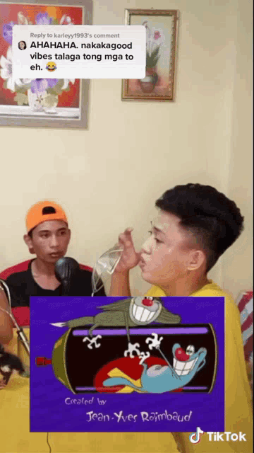 a man drinking from a bottle with a picture of a cartoon character behind him