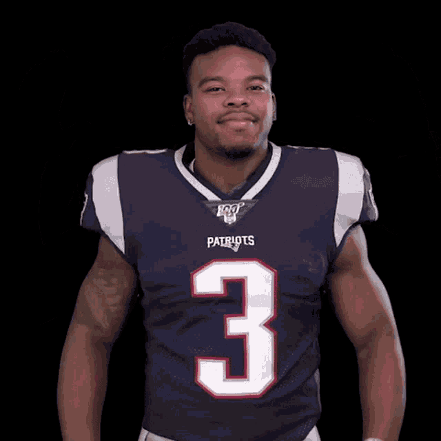 a man wearing a patriots jersey with the number 3 on the front