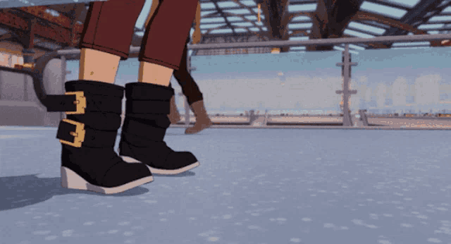 a pair of black boots with gold buckles on them