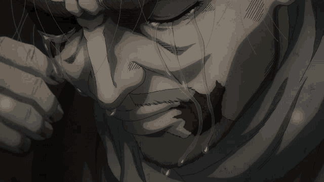 a man with blood on his face is crying with tears coming out of his eyes