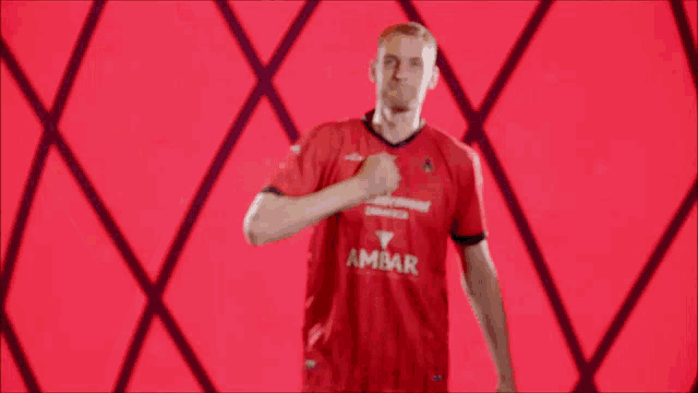 a man in a red shirt with the word ambar on the front