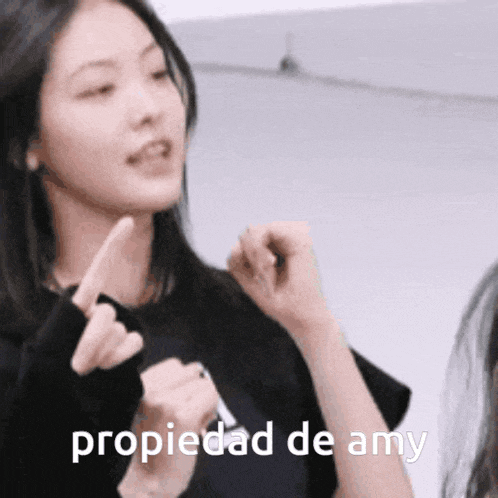 a woman making a funny face with the words propiedad de amy written below her