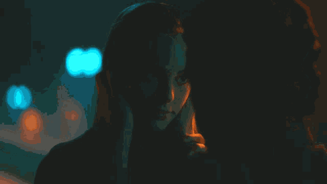 a woman 's face is being touched by a man 's arm
