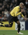 a soccer player wearing a yellow shirt and black shorts is running on the field