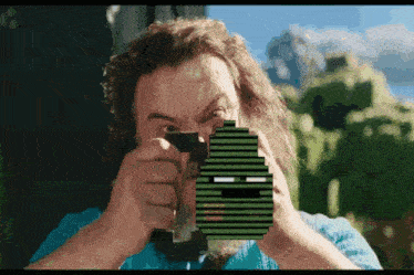 a man with a beard is holding a gun with a pixelated face on it