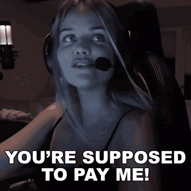 a woman with headphones and a microphone says you 're supposed to pay me