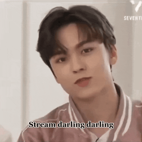 a young man in a pink shirt with the words stream darling darling on the bottom