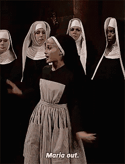 a group of nuns are standing next to each other and one of them is saying `` maria out . ''