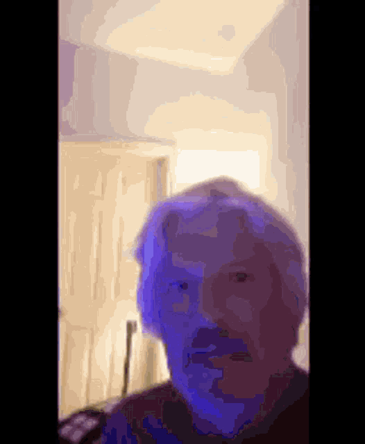 a blurry picture of a man with a blue face