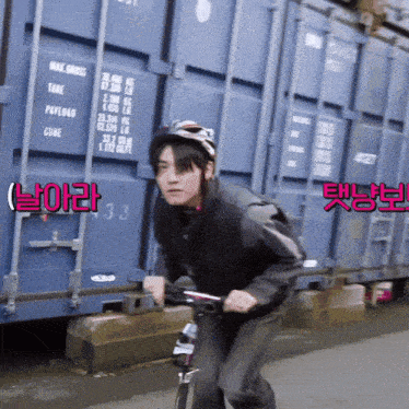 a man wearing a helmet is riding a scooter in front of a blue container with the number 33 on it
