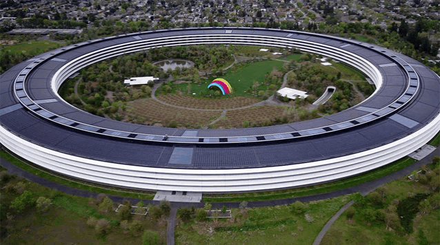 an aerial view of a large building with a rainbow in the middle of it