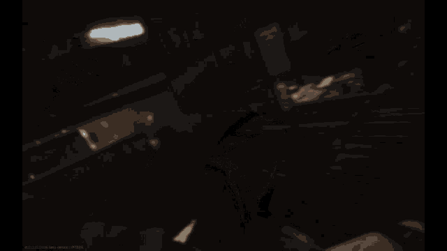 a blurred image of a person holding a gun in a dark room with a red spot in the middle